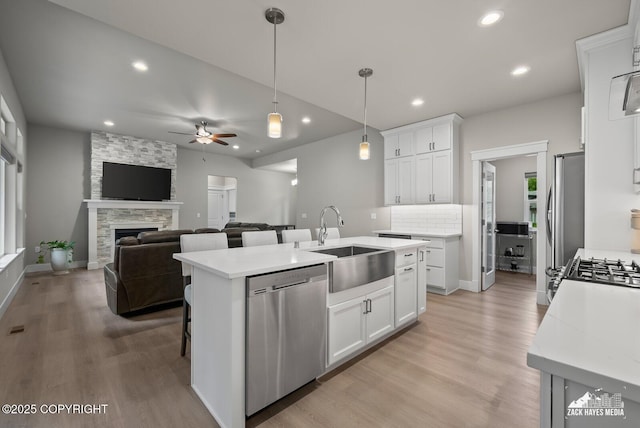 8028 E Yarn Spinner Cir, Palmer, AK 99645 - kitchen featuring stainless steel appliances, light wood-style flooring, white cabinets, recessed lighting, and ceiling fan
