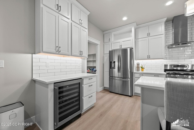8028 E Yarn Spinner Cir, Palmer, AK 99645 - kitchen featuring stainless steel appliances, beverage cooler, wall chimney exhaust hood, light countertops, and backsplash