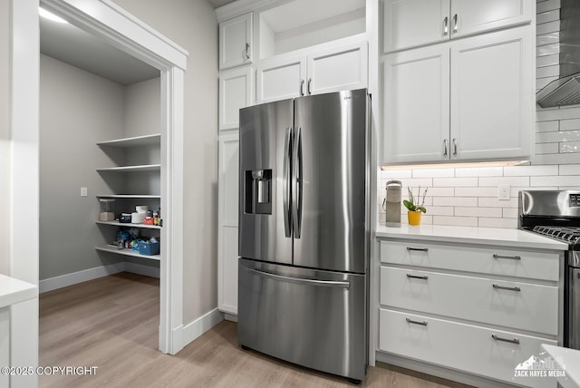 8028 E Yarn Spinner Cir, Palmer, AK 99645 - kitchen featuring stainless steel appliances, light countertops, tasteful backsplash, and wall chimney exhaust hood