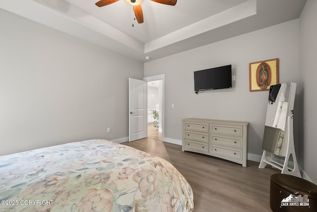 8028 E Yarn Spinner Cir, Palmer, AK 99645 - bedroom featuring wood finished floors, a tray ceiling, and ceiling fan