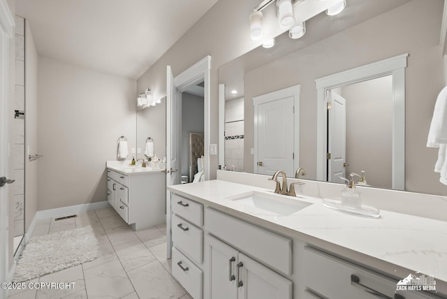 8028 E Yarn Spinner Cir, Palmer, AK 99645 - bathroom featuring two vanities and marble look tile flooring