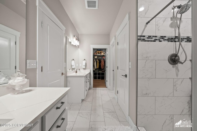 8028 E Yarn Spinner Cir, Palmer, AK 99645 - bathroom with marble finish flooring, two vanities, a stall shower, and a spacious closet