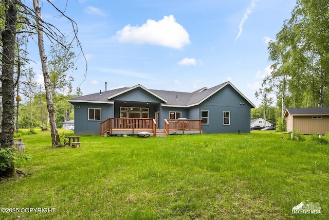 8028 E Yarn Spinner Cir, Palmer, AK 99645 - back of house with a deck, a lawn, and roof with shingles