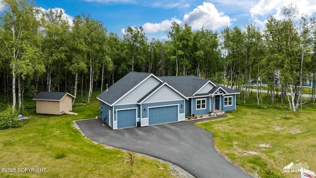 8028 E Yarn Spinner Cir, Palmer, AK 99645 - view of front facade featuring an attached garage, driveway, a front lawn, and a storage shed