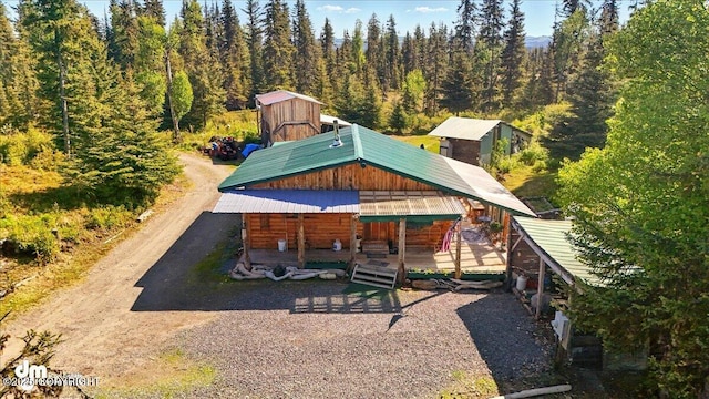 71252 Siri, Anchor Point, AK 99556 - back of property featuring a view of trees, a metal roof, and dirt driveway