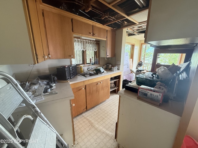 406 Mitkof Hwy, Petersburg, AK 99833 - kitchen featuring light floors, light countertops, brown cabinetry, and black microwave
