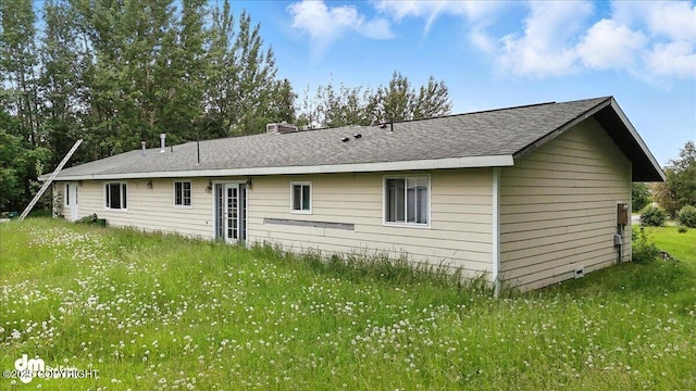 701 N Luke St, Wasilla, AK 99654 - rear view of property with a chimney, a shingled roof, and a lawn