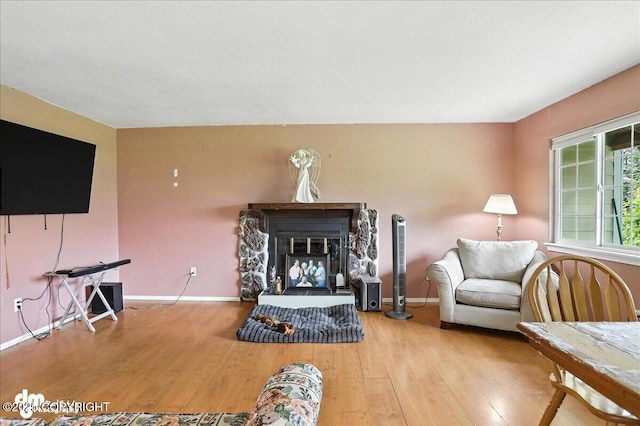 701 N Luke St, Wasilla, AK 99654 - living area featuring wood finished floors and a stone fireplace