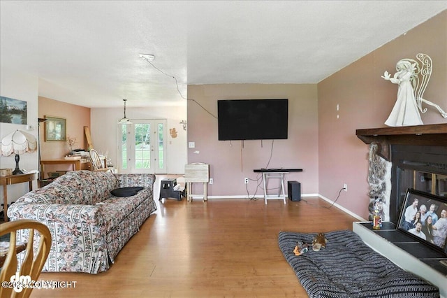 701 N Luke St, Wasilla, AK 99654 - living room with french doors, wood finished floors, and a glass covered fireplace