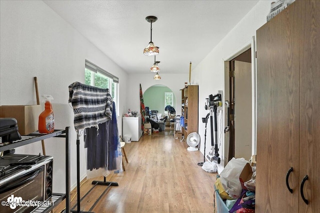 701 N Luke St, Wasilla, AK 99654 - hallway featuring light wood-type flooring and arched walkways