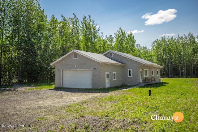 2390 Edsson Ave, North Pole, AK 99705 - view of side of home with dirt driveway, a garage, and a yard