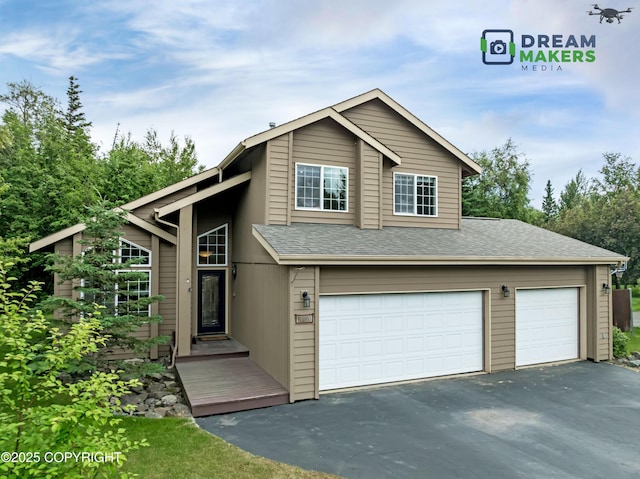 11240 E Equestrian St, Palmer, AK 99645 - view of front of house featuring asphalt driveway, a garage, and a shingled roof