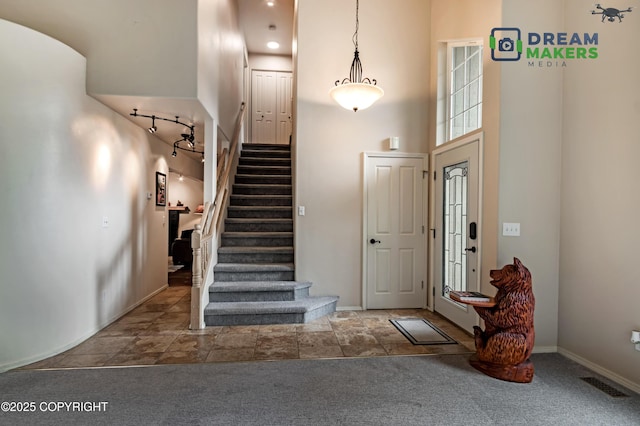11240 E Equestrian St, Palmer, AK 99645 - carpeted entryway with stairs and a towering ceiling