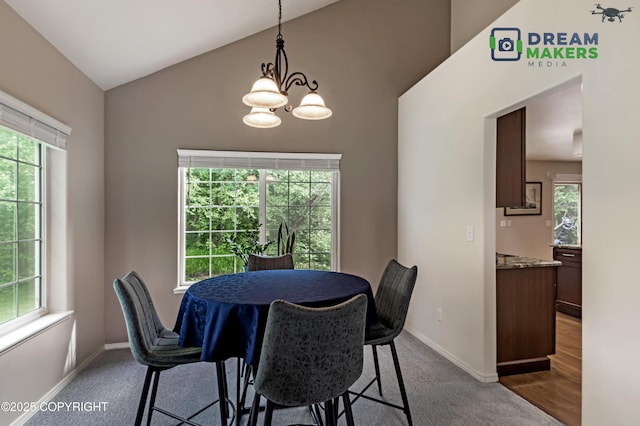 11240 E Equestrian St, Palmer, AK 99645 - dining room with lofted ceiling, a chandelier, and dark colored carpet