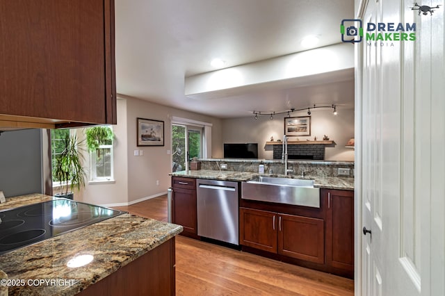11240 E Equestrian St, Palmer, AK 99645 - kitchen with stainless steel dishwasher, light wood finished floors, a peninsula, stone countertops, and range