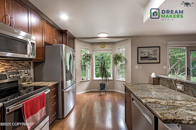 11240 E Equestrian St, Palmer, AK 99645 - kitchen featuring appliances with stainless steel finishes, light stone counters, tasteful backsplash, dark wood-type flooring, and recessed lighting