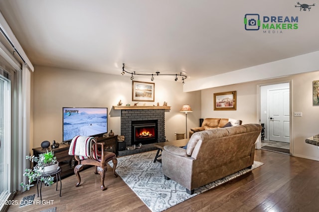 11240 E Equestrian St, Palmer, AK 99645 - living area with wood finished floors, a brick fireplace, and track lighting