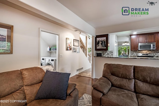 11240 E Equestrian St, Palmer, AK 99645 - living room with washing machine and clothes dryer, wood finished floors, and stairs
