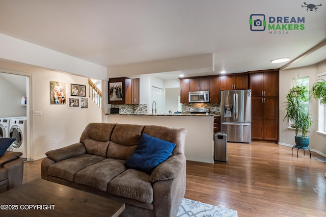 11240 E Equestrian St, Palmer, AK 99645 - living area with washing machine and clothes dryer, wood finished floors, recessed lighting, and stairs