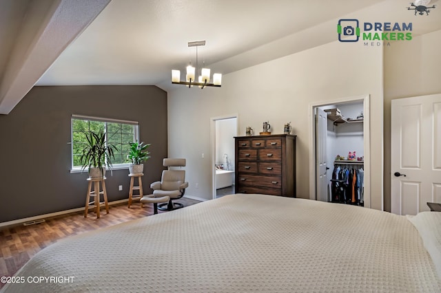 11240 E Equestrian St, Palmer, AK 99645 - bedroom with wood finished floors, a chandelier, vaulted ceiling, a walk in closet, and a closet