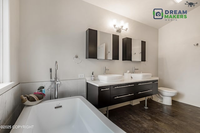 11240 E Equestrian St, Palmer, AK 99645 - full bathroom featuring a soaking tub, double vanity, and wood finished floors