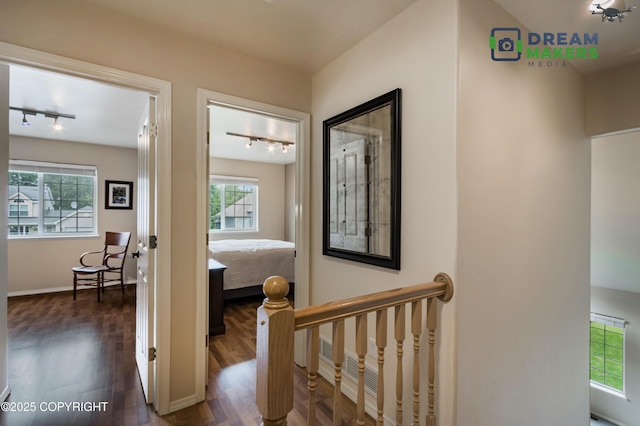 11240 E Equestrian St, Palmer, AK 99645 - hallway featuring track lighting, healthy amount of natural light, and dark wood-style floors
