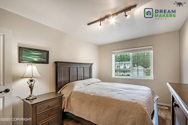 11240 E Equestrian St, Palmer, AK 99645 - bedroom featuring track lighting and dark wood-type flooring