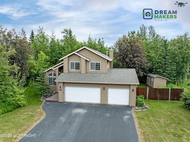 11240 E Equestrian St, Palmer, AK 99645 - view of front of house featuring asphalt driveway, a garage, a chimney, and roof with shingles