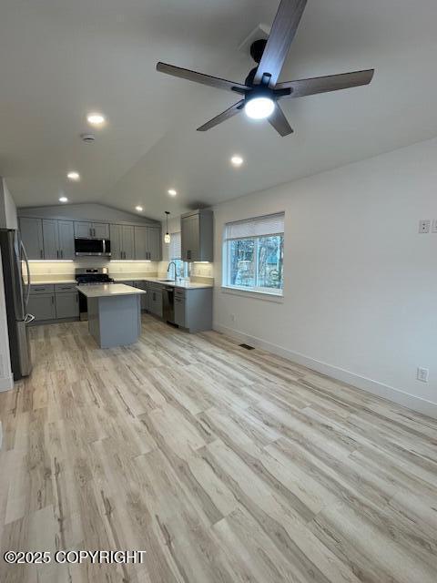 2033 E Chickaloon Rd, Wasilla, AK 99654 - kitchen featuring gray cabinets, stainless steel appliances, a ceiling fan, a kitchen island, and vaulted ceiling
