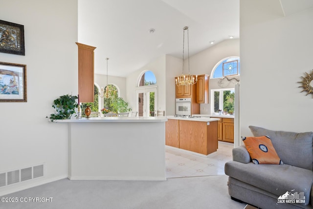 10100 Zermatt Cir, Anchorage, AK 99507 - kitchen with white appliances, high vaulted ceiling, light countertops, a chandelier, and open floor plan