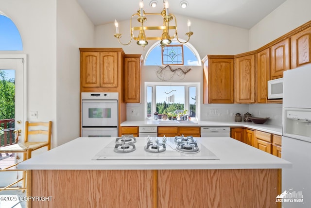 10100 Zermatt Cir, Anchorage, AK 99507 - kitchen featuring white appliances, lofted ceiling, a chandelier, light countertops, and tasteful backsplash