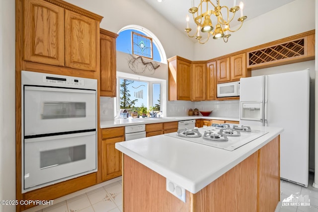 10100 Zermatt Cir, Anchorage, AK 99507 - kitchen with white appliances, light countertops, a chandelier, a center island, and a high ceiling