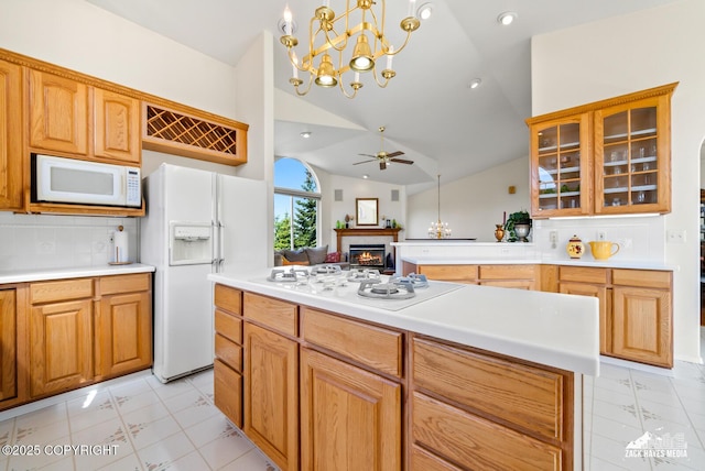 10100 Zermatt Cir, Anchorage, AK 99507 - kitchen featuring white appliances, a lit fireplace, ceiling fan, a chandelier, and glass insert cabinets
