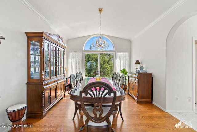10100 Zermatt Cir, Anchorage, AK 99507 - dining space with arched walkways, a chandelier, lofted ceiling, and ornamental molding