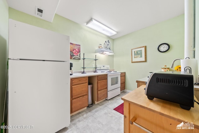 10100 Zermatt Cir, Anchorage, AK 99507 - kitchen with white appliances, light countertops, and brown cabinets