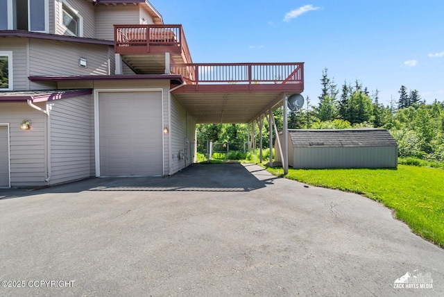 10100 Zermatt Cir, Anchorage, AK 99507 - view of side of property with asphalt driveway, a yard, a deck, a garage, and a carport
