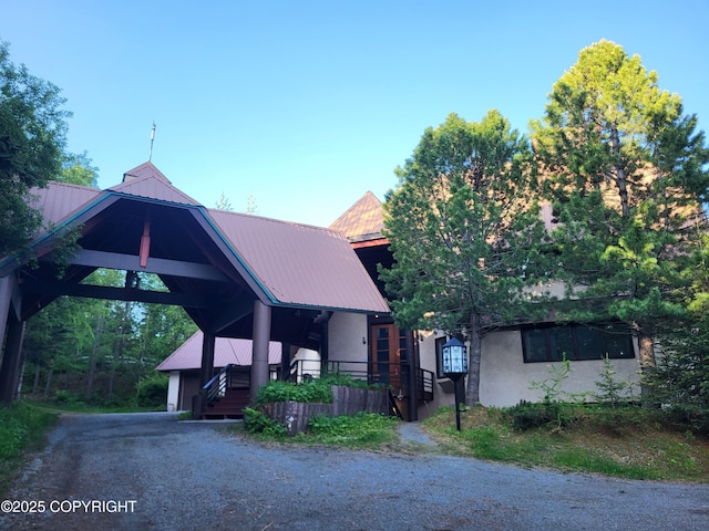 9921 Nearpoint Dr, Anchorage, AK 99507 - view of front of home with a metal roof and stucco siding