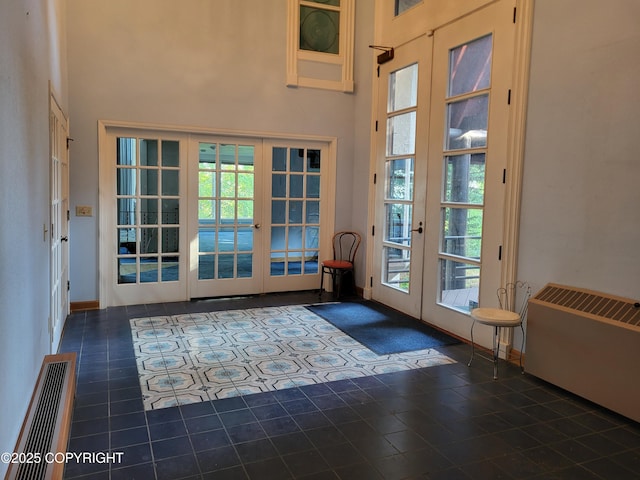 9921 Nearpoint Dr, Anchorage, AK 99507 - doorway to outside with french doors, a towering ceiling, tile patterned flooring, and radiator heating unit