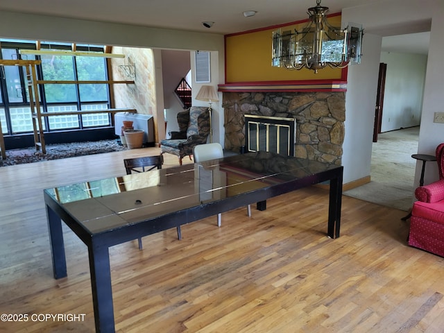 9921 Nearpoint Dr, Anchorage, AK 99507 - living area with wood finished floors, a chandelier, and a fireplace