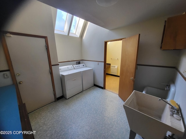 9921 Nearpoint Dr, Anchorage, AK 99507 - laundry area with a skylight, washer and dryer, and radiator heating unit