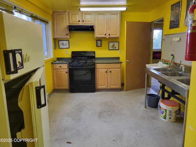 9921 Nearpoint Dr, Anchorage, AK 99507 - kitchen featuring black gas range, exhaust hood, freestanding refrigerator, and dark countertops