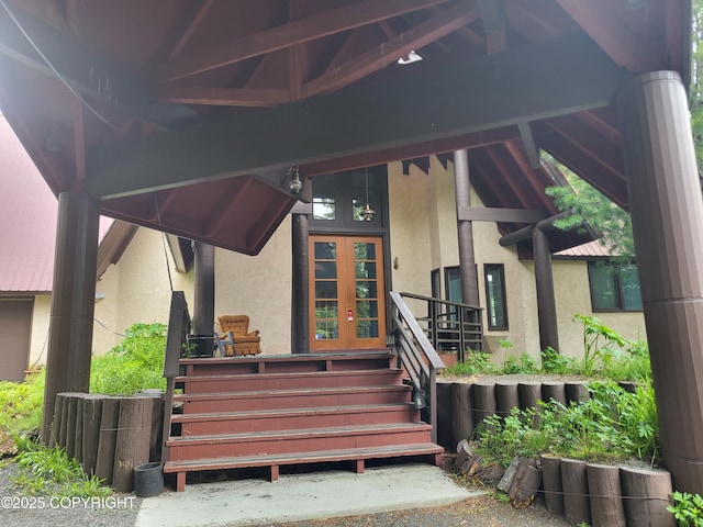 9921 Nearpoint Dr, Anchorage, AK 99507 - view of exterior entry featuring stucco siding and french doors
