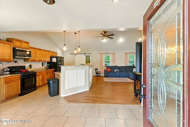 1708 Wesbet Ct, Kenai, AK 99611 - kitchen featuring black appliances, open floor plan, lofted ceiling, light countertops, and light tile patterned flooring