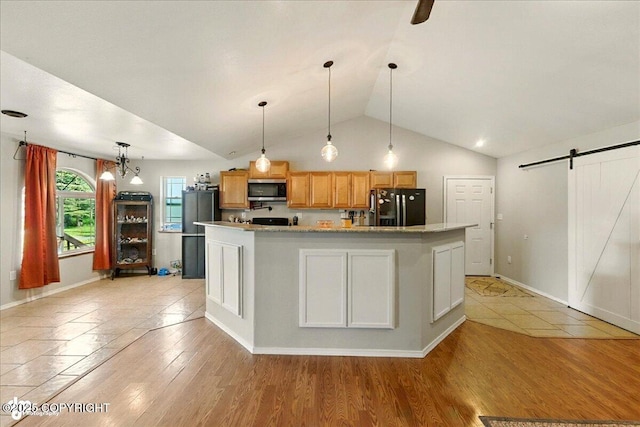 1708 Wesbet Ct, Kenai, AK 99611 - kitchen featuring black refrigerator with ice dispenser, stainless steel microwave, a barn door, lofted ceiling, and decorative light fixtures