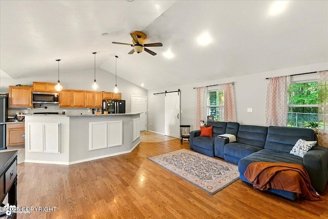 1708 Wesbet Ct, Kenai, AK 99611 - living room with a barn door, a ceiling fan, light wood finished floors, and high vaulted ceiling