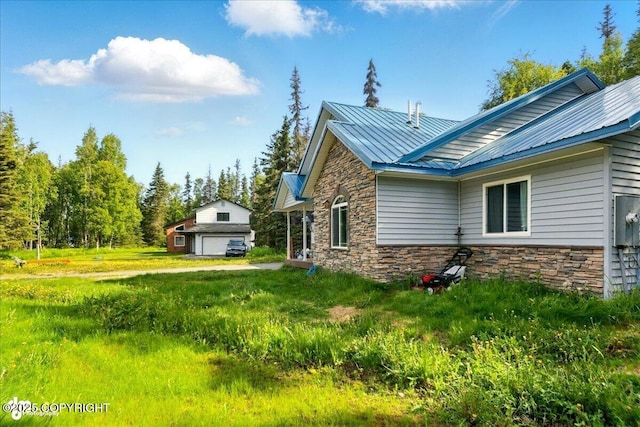 1708 Wesbet Ct, Kenai, AK 99611 - view of home's exterior featuring stone siding and a metal roof
