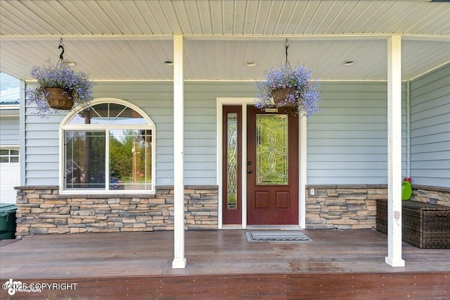 1708 Wesbet Ct, Kenai, AK 99611 - view of exterior entry featuring stone siding and a porch