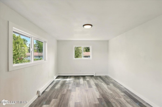 309 Stewart St, Anchorage, AK 99508 - spare room with baseboard heating and wood finished floors