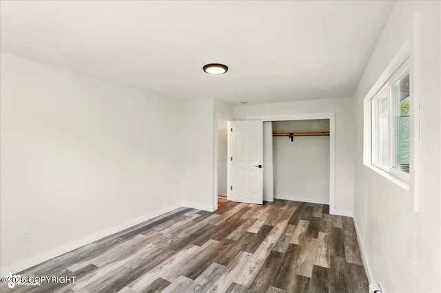 309 Stewart St, Anchorage, AK 99508 - unfurnished bedroom with dark wood-style flooring and a closet