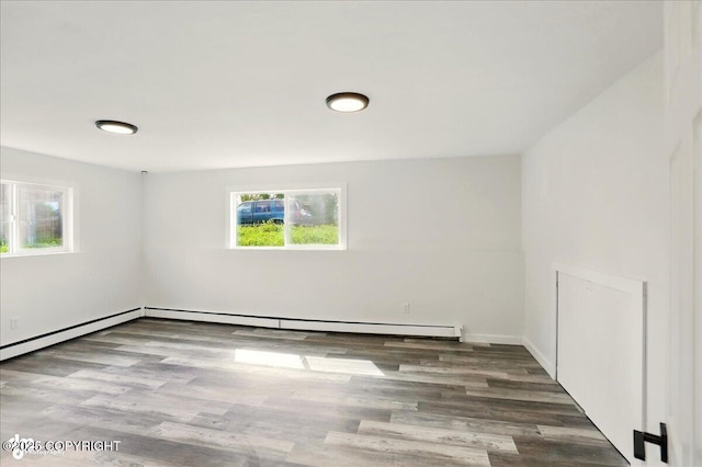 309 Stewart St, Anchorage, AK 99508 - spare room featuring wood finished floors and a baseboard radiator